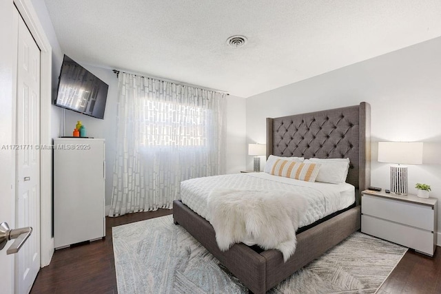 bedroom with dark hardwood / wood-style flooring