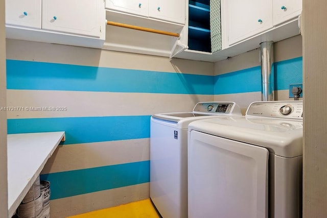 laundry room with cabinets and washing machine and clothes dryer