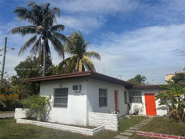 view of front of home featuring fence and stucco siding