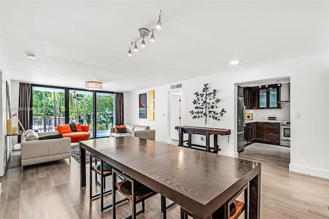 dining space with light hardwood / wood-style floors