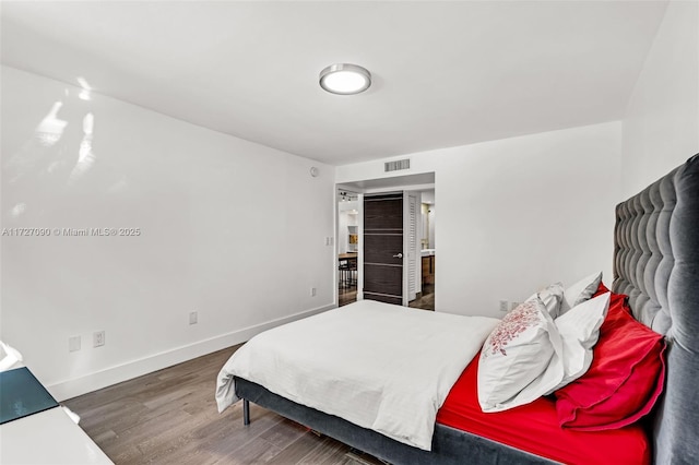 bedroom with dark hardwood / wood-style flooring