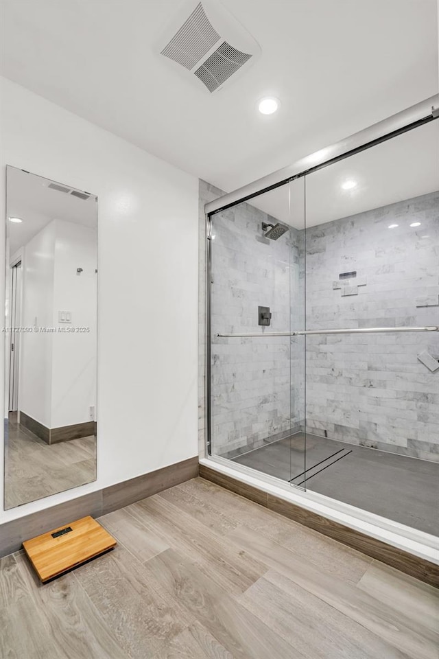 bathroom featuring a shower with shower door