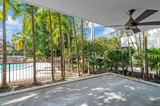 unfurnished sunroom featuring ceiling fan and plenty of natural light