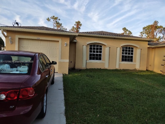 view of front of home with a garage and a front yard