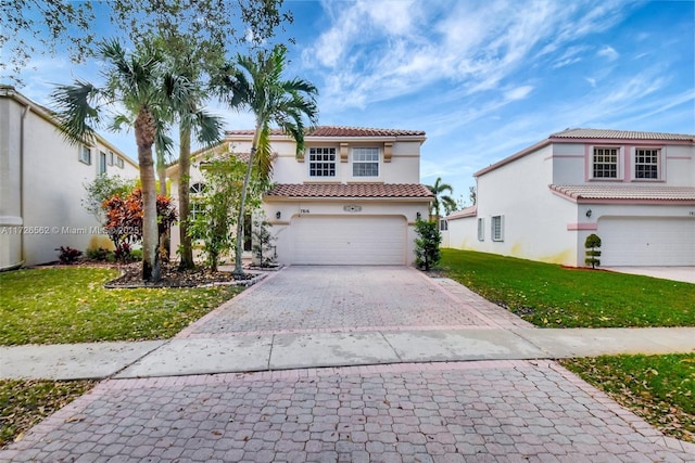 mediterranean / spanish-style house with a garage and a front yard