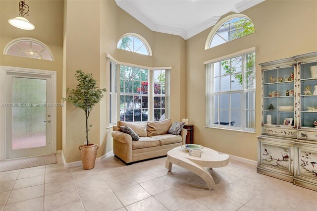 unfurnished room featuring an inviting chandelier, lofted ceiling, ornamental molding, and light tile patterned floors