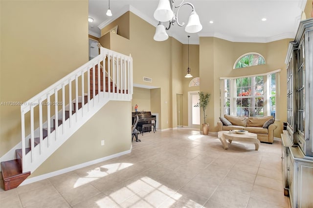 interior space featuring a towering ceiling, ornamental molding, and a chandelier