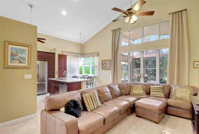 kitchen featuring light tile patterned flooring, appliances with stainless steel finishes, decorative backsplash, ornamental molding, and light stone counters