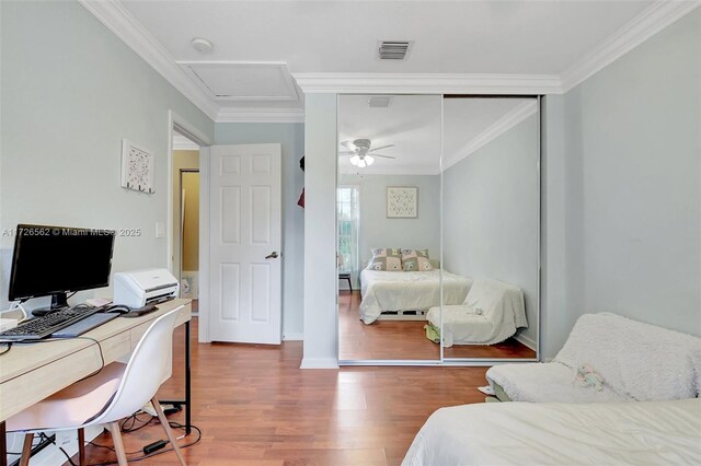 bedroom featuring ornamental molding, ceiling fan, and dark hardwood / wood-style flooring