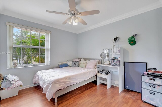 bedroom featuring crown molding, hardwood / wood-style floors, and a closet