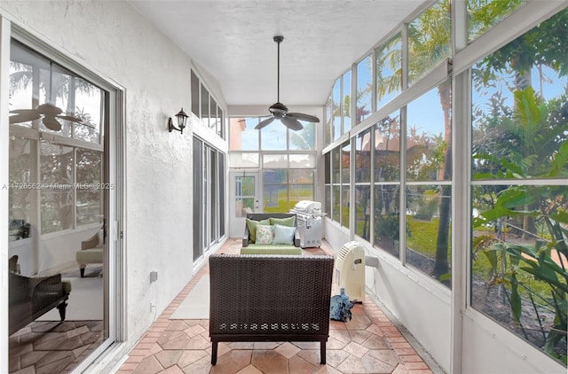 sunroom / solarium featuring ceiling fan