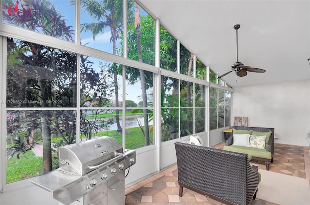 sunroom / solarium with vaulted ceiling, a water view, and ceiling fan