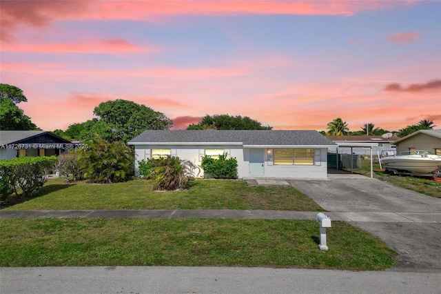 single story home featuring a yard and a carport