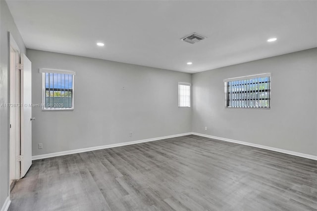 unfurnished room with hardwood / wood-style floors