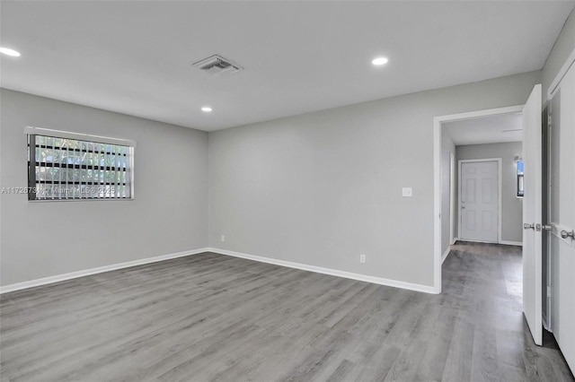 unfurnished room featuring hardwood / wood-style flooring