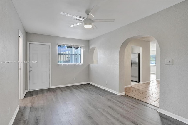 empty room with ceiling fan and wood-type flooring