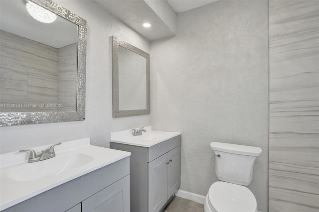 bathroom featuring toilet, tile patterned flooring, and vanity