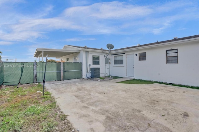 rear view of property featuring central AC and a patio