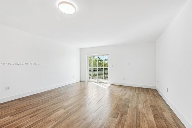 unfurnished room with light hardwood / wood-style floors