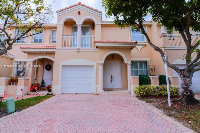 mediterranean / spanish-style house with a balcony and a garage