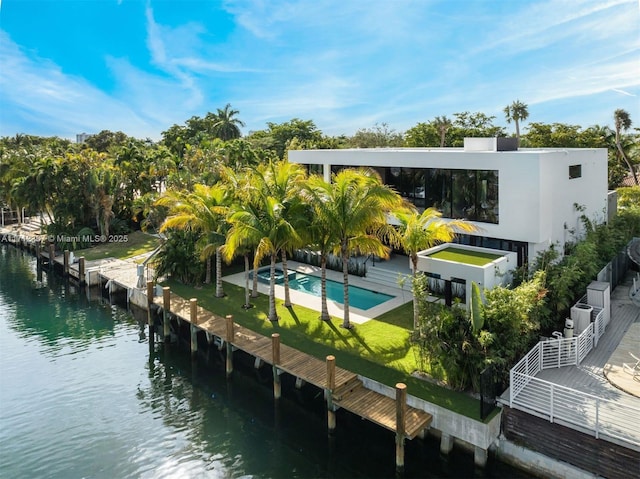 rear view of property featuring a water view and a patio