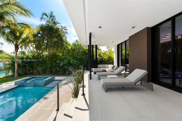 view of pool featuring an outdoor hangout area, an in ground hot tub, and a patio