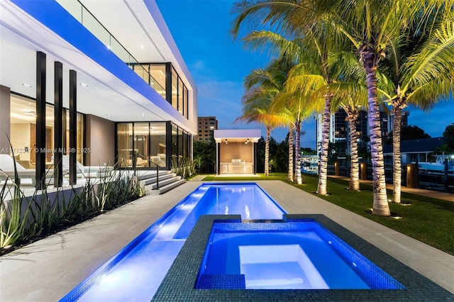 view of swimming pool with an in ground hot tub and a patio