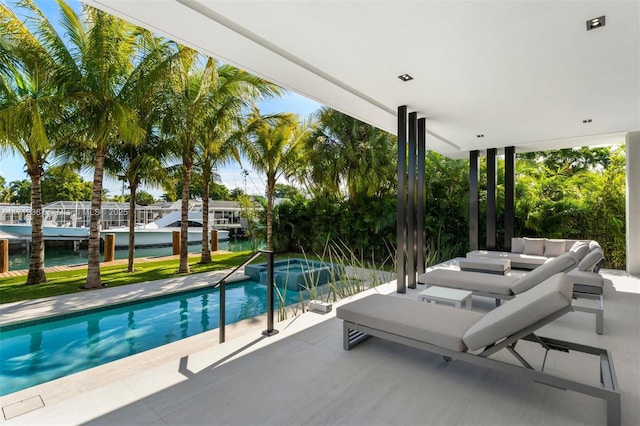 view of pool with a water view and a patio area