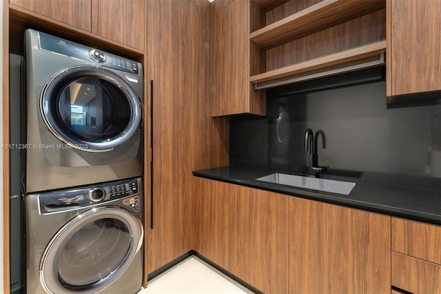 laundry room with sink and stacked washing maching and dryer