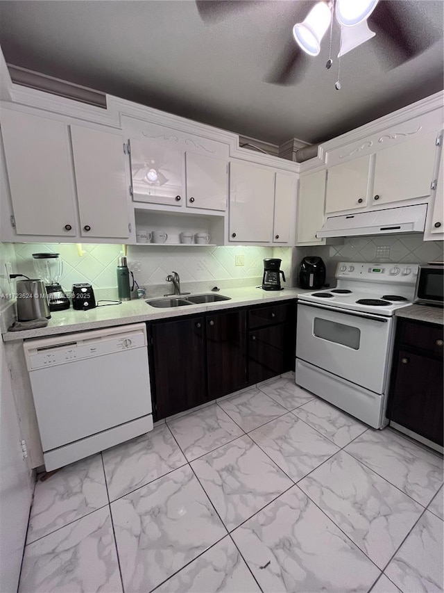 kitchen with ceiling fan, sink, white appliances, and white cabinetry