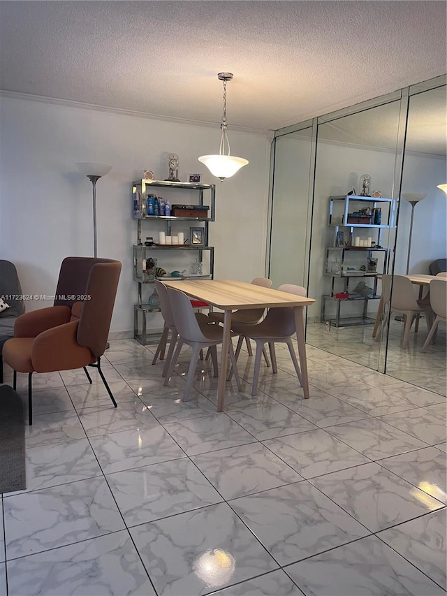 dining area with a textured ceiling and crown molding