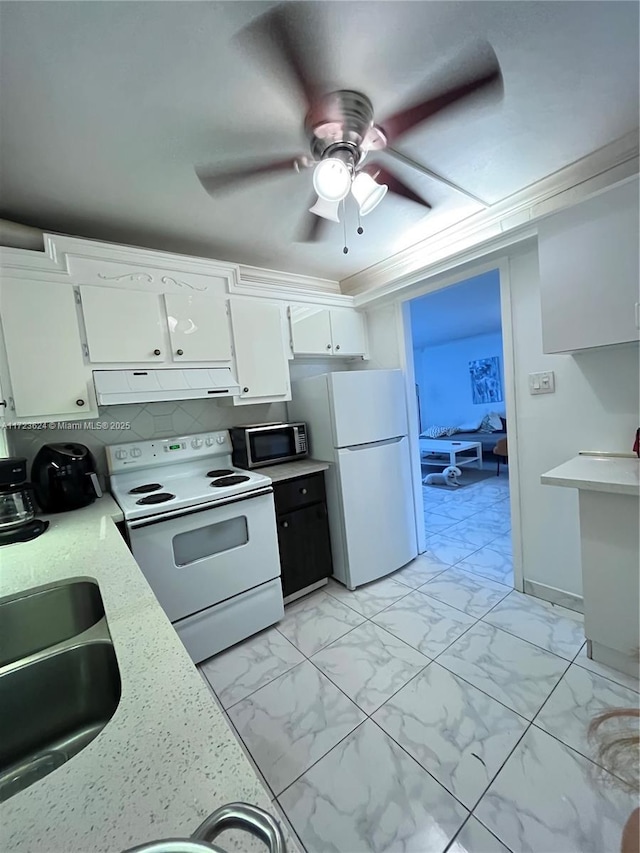 kitchen with ceiling fan, backsplash, white appliances, white cabinets, and sink