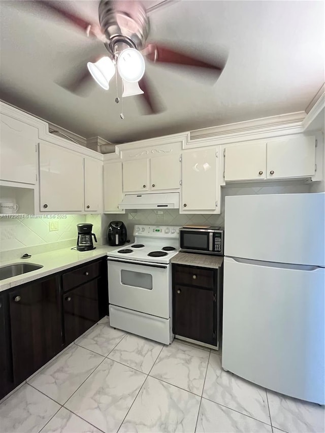 kitchen with ceiling fan, backsplash, white appliances, white cabinets, and sink