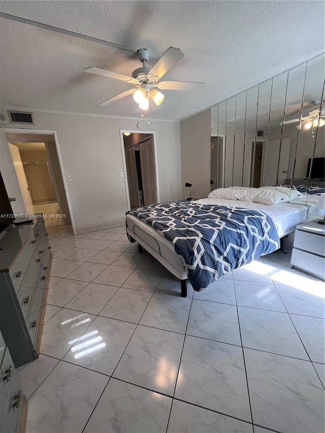 bedroom with a textured ceiling and ceiling fan