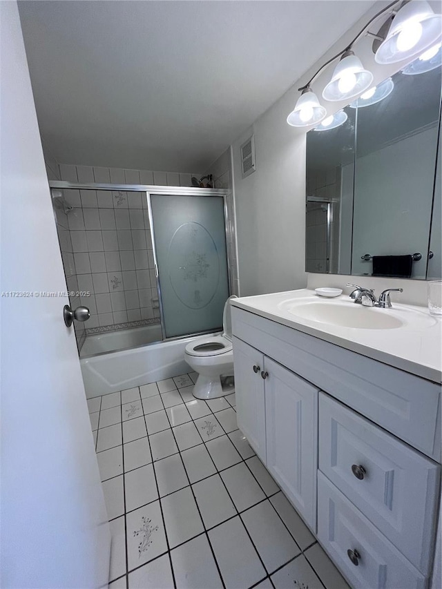 full bathroom with toilet, bath / shower combo with glass door, tile patterned flooring, and vanity