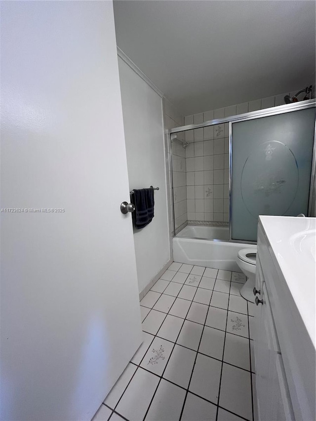 full bathroom featuring toilet, enclosed tub / shower combo, tile patterned flooring, and vanity