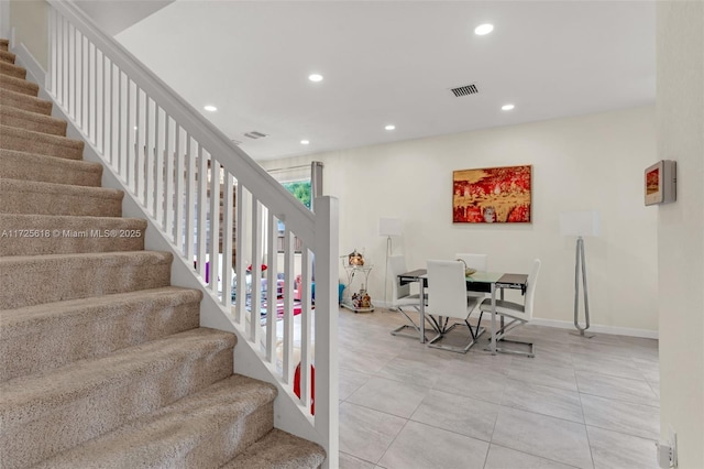 stairs featuring tile patterned flooring