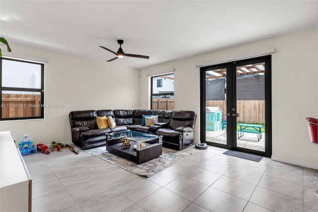 living room with light tile patterned flooring, ceiling fan, a wealth of natural light, and french doors