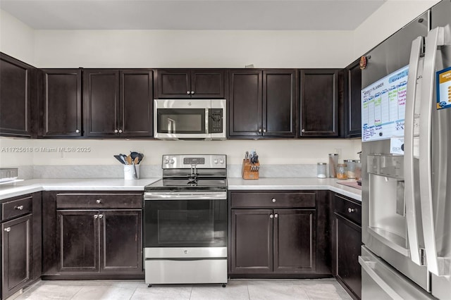 kitchen with appliances with stainless steel finishes and dark brown cabinetry