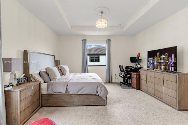 carpeted bedroom featuring a tray ceiling