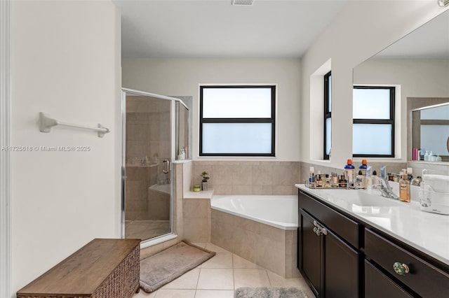 bathroom featuring independent shower and bath, tile patterned flooring, and vanity