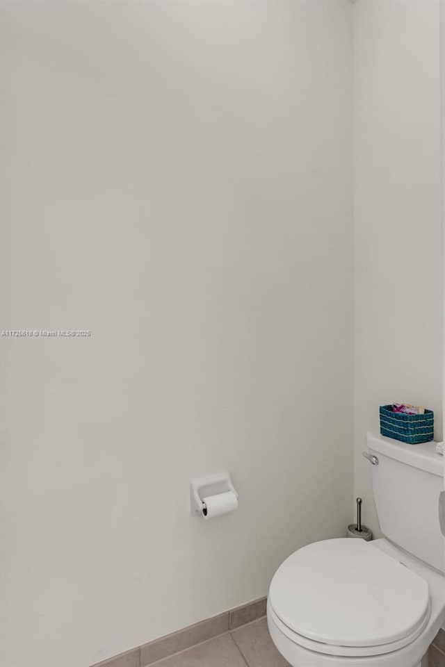 bathroom with toilet and tile patterned flooring