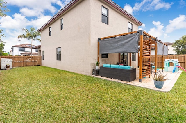 back of property featuring an outdoor living space, a yard, and a patio