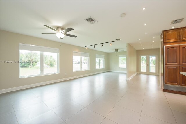 kitchen featuring tasteful backsplash, ceiling fan, a kitchen island, pendant lighting, and rail lighting