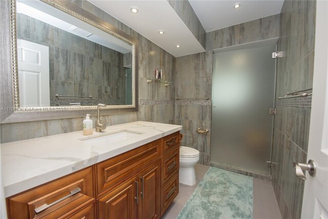 full bathroom featuring toilet, tiled shower / bath combo, vanity, and tile patterned floors