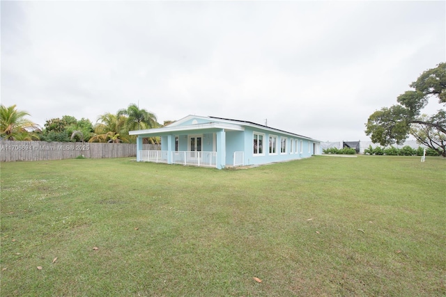 exterior space with a lawn and fence