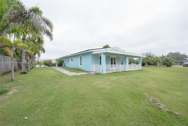 ranch-style home featuring a front lawn and ac unit