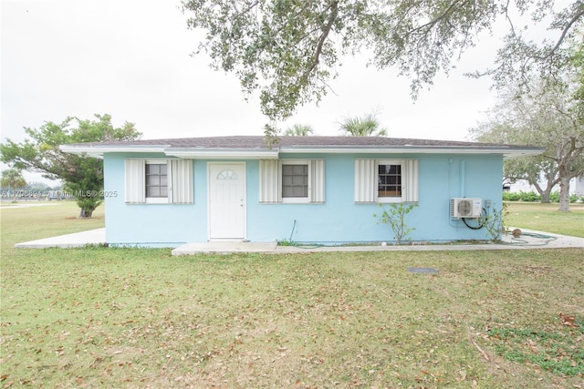 single story home with a front lawn, ac unit, and stucco siding