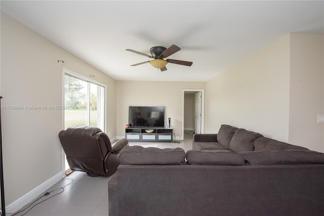 living room featuring ceiling fan, light tile patterned floors, and baseboards