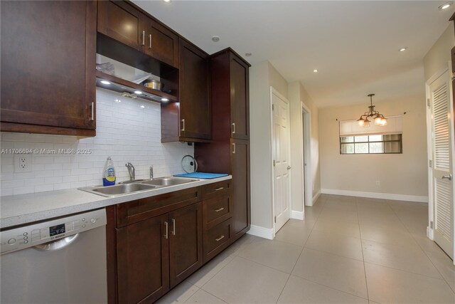 kitchen featuring stainless steel appliances, tasteful backsplash, hanging light fixtures, a notable chandelier, and light tile patterned floors